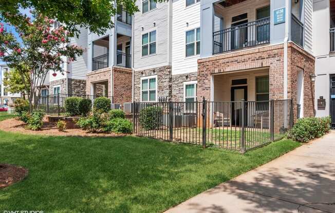 our apartments have a fenced in yard and green grass