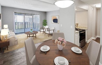 a dining area with a wooden table and chairs and a kitchen in the background at Planters Trace, Charleston, 29414