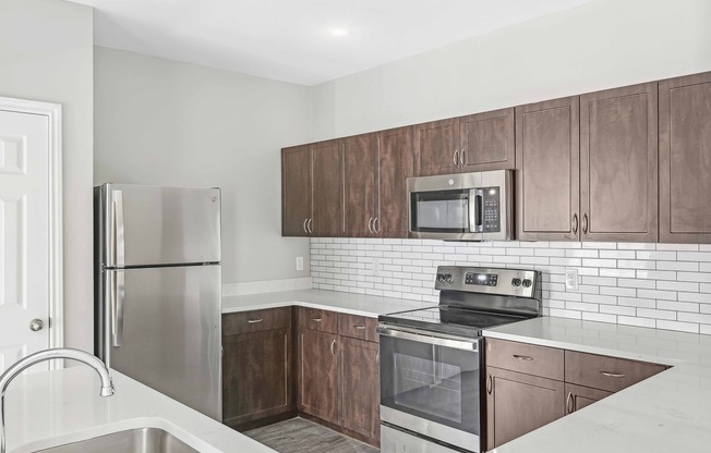 Upgraded kitchens include ENERGY STAR® stainless steel appliances, quartz countertops, and stylish tile backsplash.