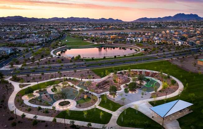 an aerial view of the skate park at sunset with the city in the background