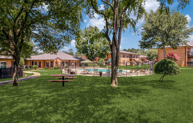 a backyard with a picnic table and a pool