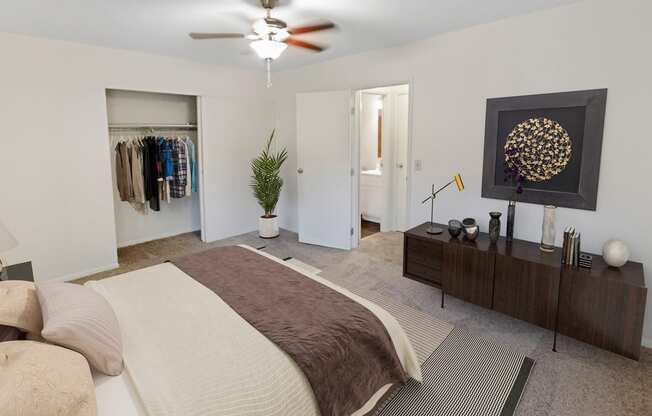 This is a photo of the digitally staged primary bedroom of a 742 square foot, 2 bedroom apartment at Romaine Court Apartments in Cincinnati, Ohio.