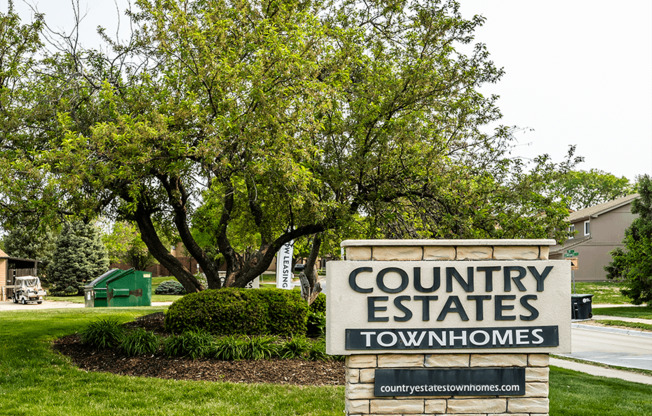 a welcome sign for Country Estates townhomes