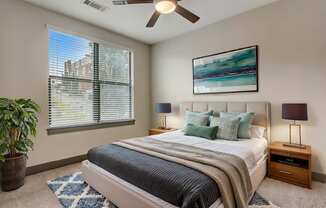 Nashville Apartments - Octave Apartments - Bedroom with plush carpet, ceiling fan, and large windows with natural light