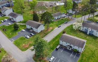 an aerial view of a neighborhood of houses with cars parked