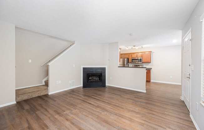 a living room with a fireplace and wooden floors