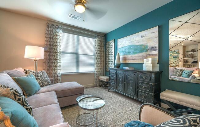 a living room filled with furniture and a large window