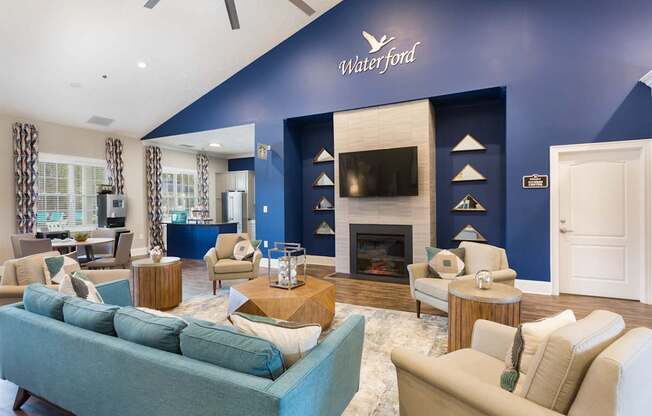 A living room with a blue couch and a fireplace.