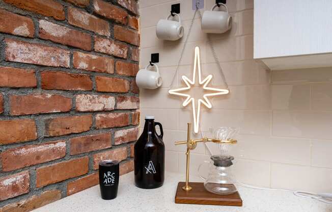 a christmas star hanging on a kitchen wall next to a brick wall