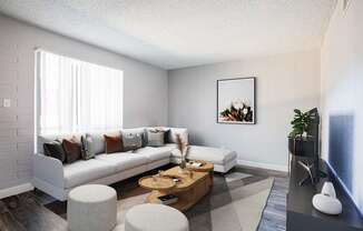 A living room with a white couch, a coffee table, and a painting on the wall.