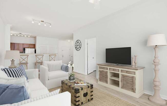 A living room with a white couch, a wooden cabinet, and a television.