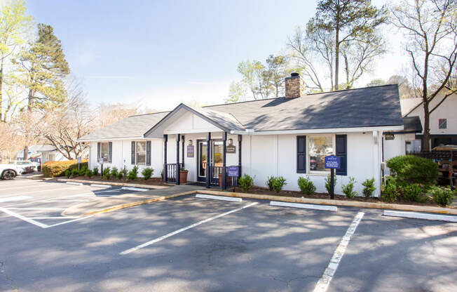 a small white building with a gray roof and a parking lot at Barcelo at East Cobb, Marietta