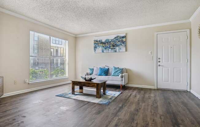 the living room of an apartment with a couch and a coffee table