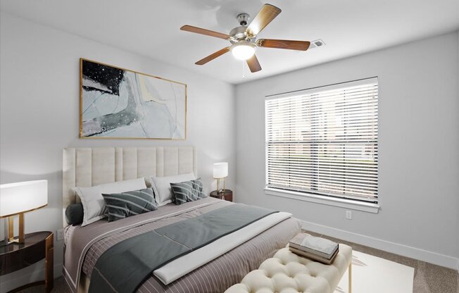 a bedroom with a large bed and a ceiling fan