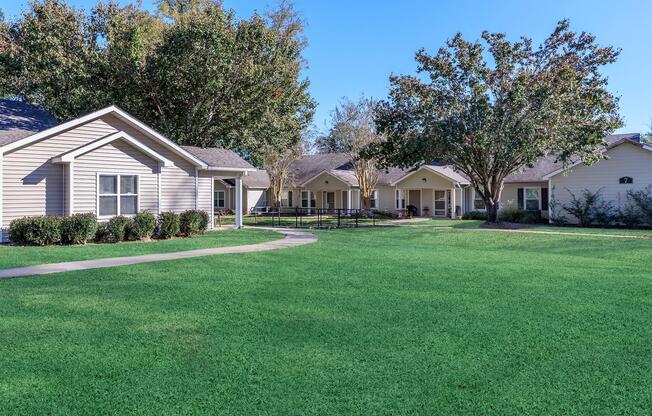 a large green field in front of a house