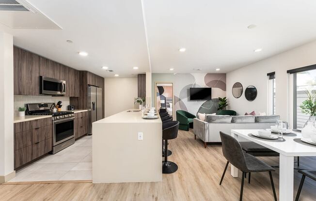 a kitchen and living room with a table and chairs