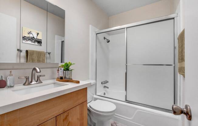 a bathroom with a toilet sink and shower