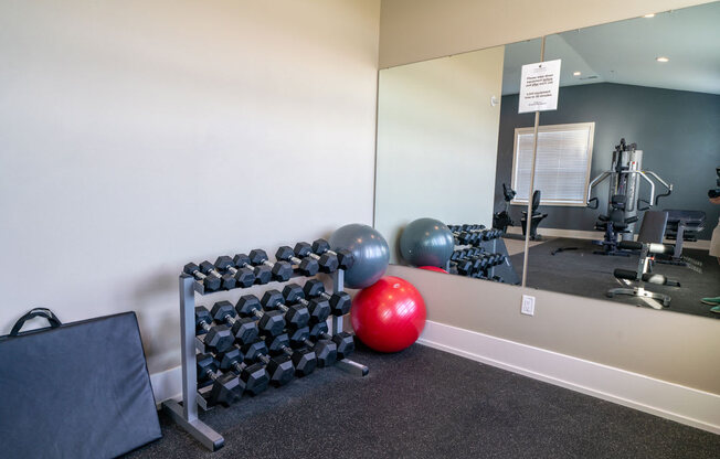 Free Weights In Gym at Strathmore Apartment Homes, West Des Moines, IA