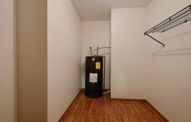 a heater in the corner of a room with a wood floor and a white wall at France, Fargo North Dakota
