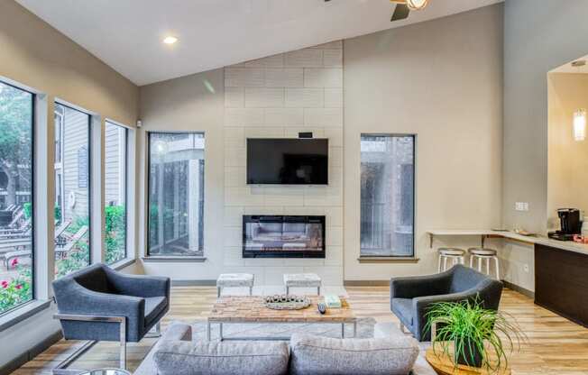 Clubhouse space with fireplace and a couch at Hillside Creek Apartments in Austin, TX
