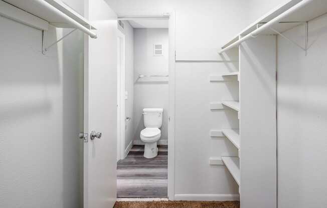 a small bathroom with white walls and wood floors