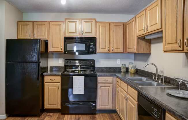 a kitchen with black appliances and wooden cabinets