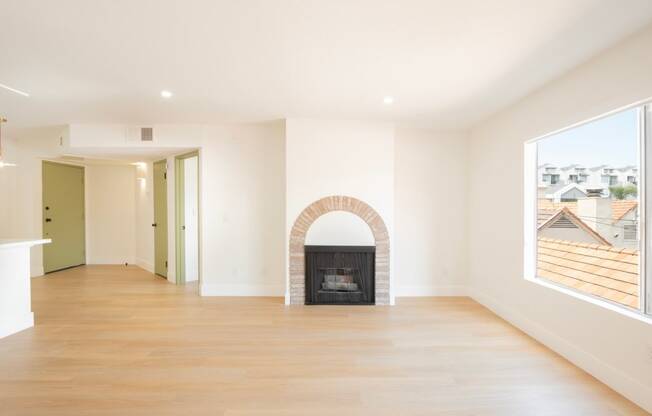 a living room with a fireplace and a wooden floor