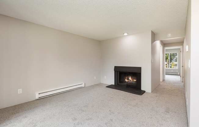 A living room with a fireplace and a carpet.
