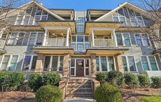 A large, two-story house with a front porch and multiple windows.