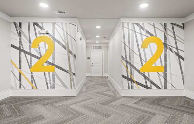 A hallway with a large number 2 painted on the wall.