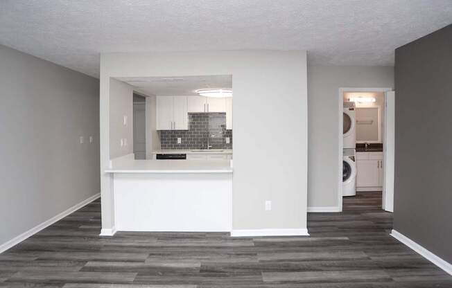 A kitchen with a white counter and a small island in the middle.