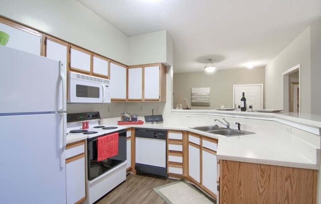 Enclave at Wolfchase Apartments in Cordova Tennessee photo of a kitchen with white cabinets and a white counter top