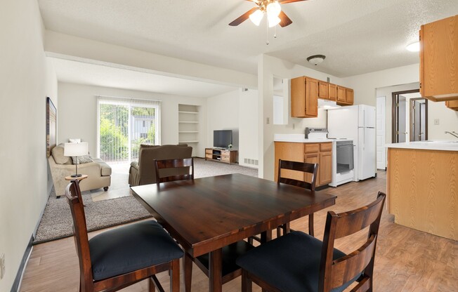 A dining room with a wooden table and chairs.