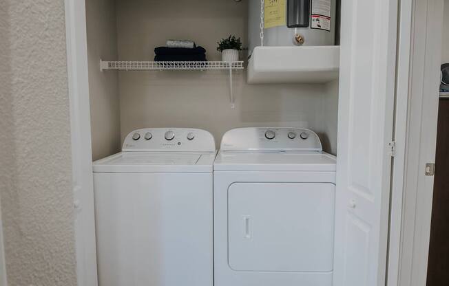 Full size washer and dryer in a small laundry room.