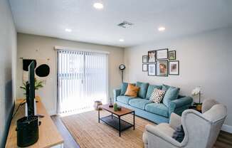 a living room with a couch and a chair and a table