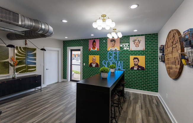 a room with green tiles and a black table and chairs
