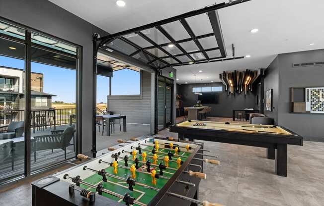 a game room with a foosball table and a pool table