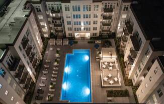 an overhead view of an apartment building with a swimming pool