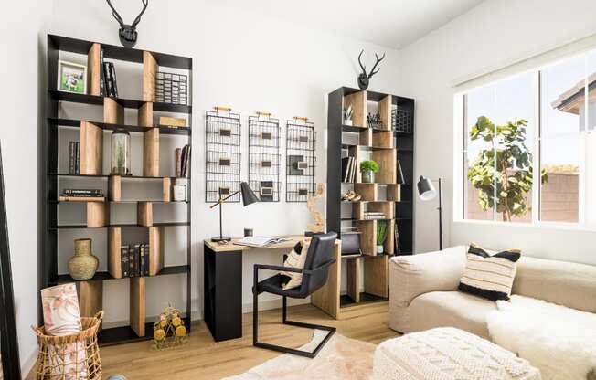 a living room with a couch and a desk in a home office