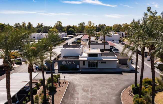 A view of a parking lot with a building that has the word AVIA on it.