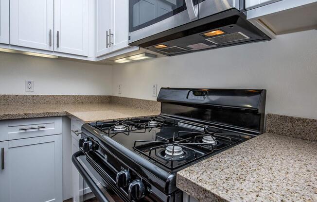 a stove top oven sitting inside of a kitchen