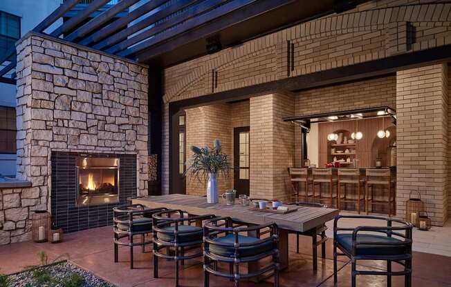 A patio with a table and chairs is set up outside a house.