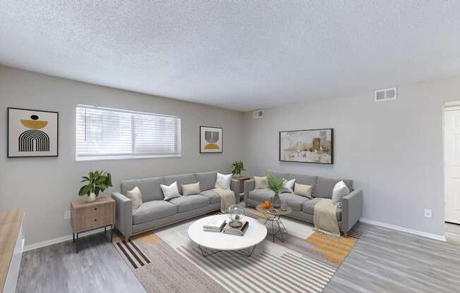 A living room with a grey couch and a coffee table.