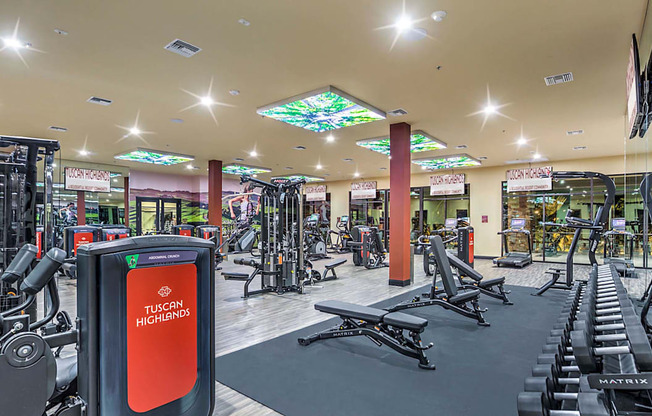 A gym with a Tuscany Higher sign on a red background.