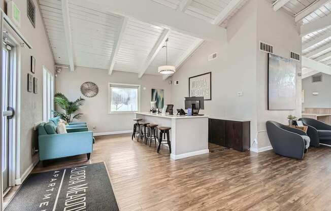 Apartments in Aurora, CO 80011 for Rent – Aurora Meadows - A spacious waiting room with a reception desk and comfortable seating.