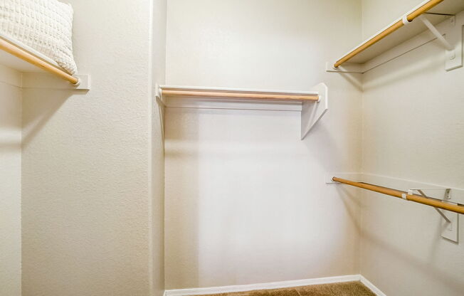the closets in our apartments are equipped with a walk in closet and shelves at Adiamo Palm Valley, Goodyear, AZ, 85395