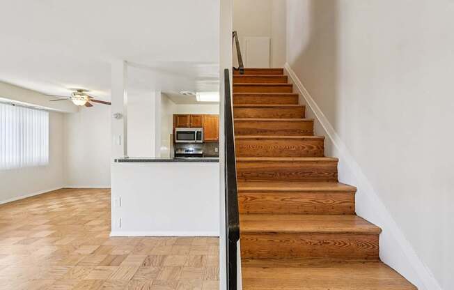A staircase leads up to a kitchen area.