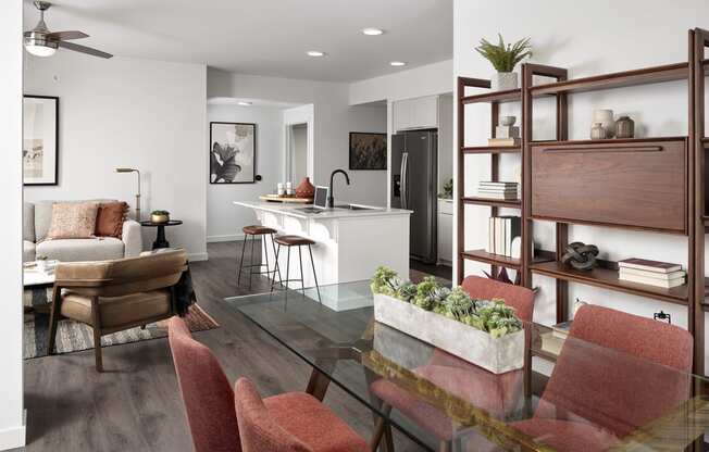 a living room and dining room with a glass table