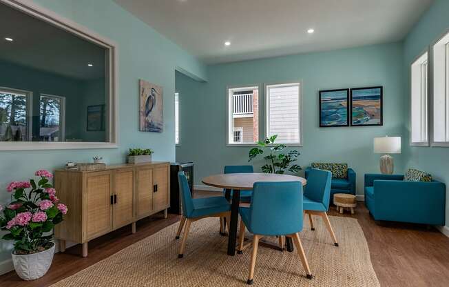 A dining room with a table set for four.