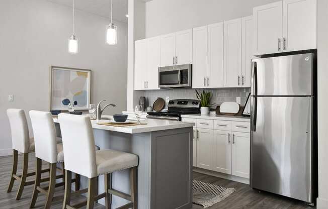 a kitchen with white cabinets and stainless steel appliances at 200 City View, Provo, Utah